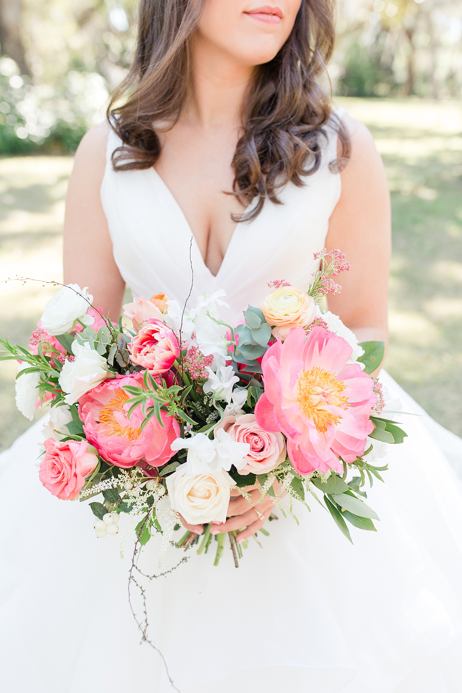 Enchanted Oaks Jacksonville Wedding Detail of Bride holding Bouquet with Coral flowers Photo