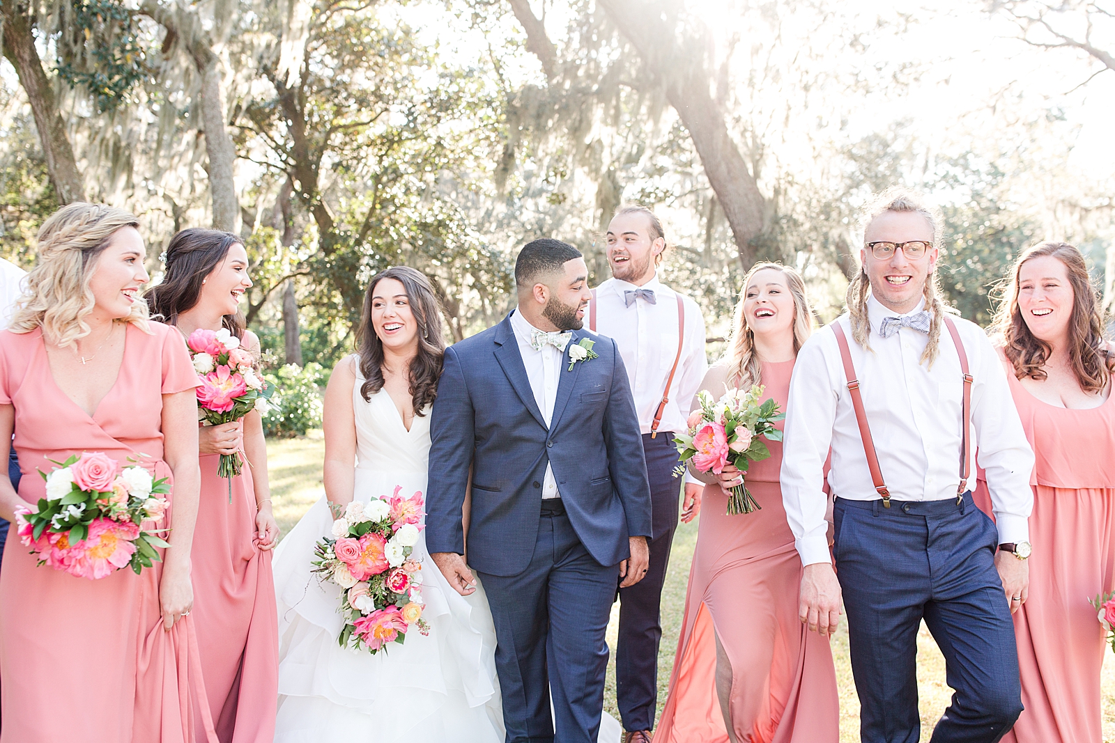 Enchanted Oaks Jacksonville Wedding Bride and Groom Walking with Bridal Party Laughing Photo