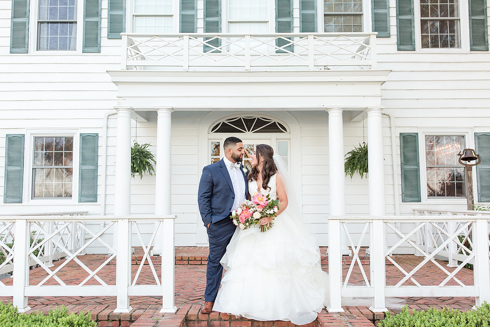 Enchanted Oaks Jacksonville Wedding Bride and Groom Smiling at Each Other on Porch of Venue Photo