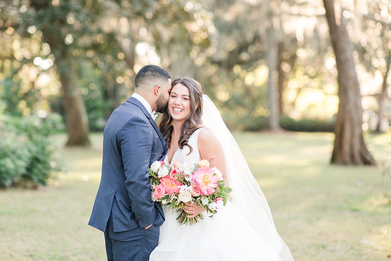 Enchanted Oaks Jacksonville Wedding Bride Smiling at Camera and Groom Nuzzling in Photo