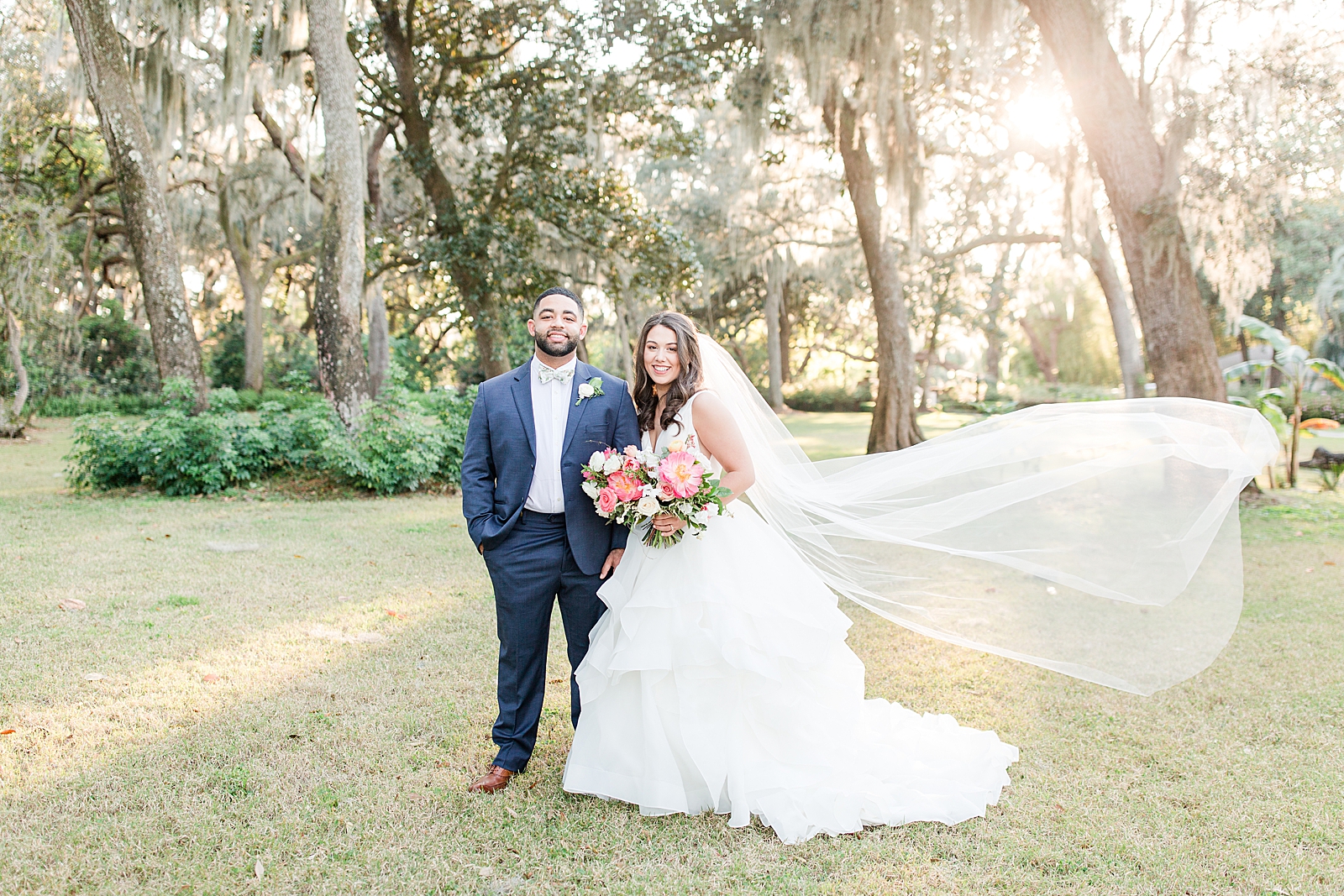 Enchanted Oaks Jacksonville Wedding Bride and Groom Smiling at Camera with Veil Blowing in Wind Photo