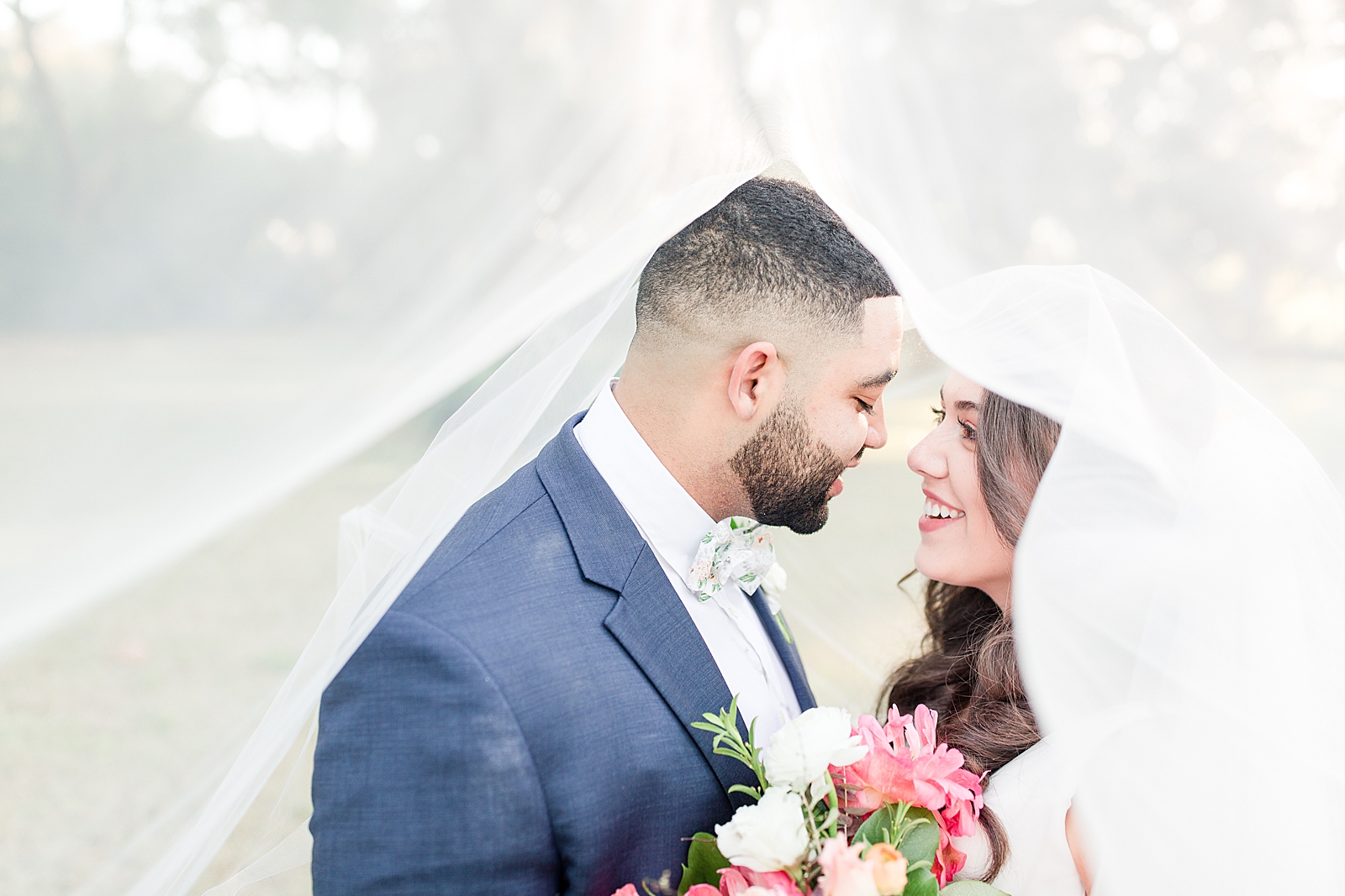 Enchanted Oaks Jacksonville Wedding Bride and Groom Smiling at Each Other Under Veil Photo