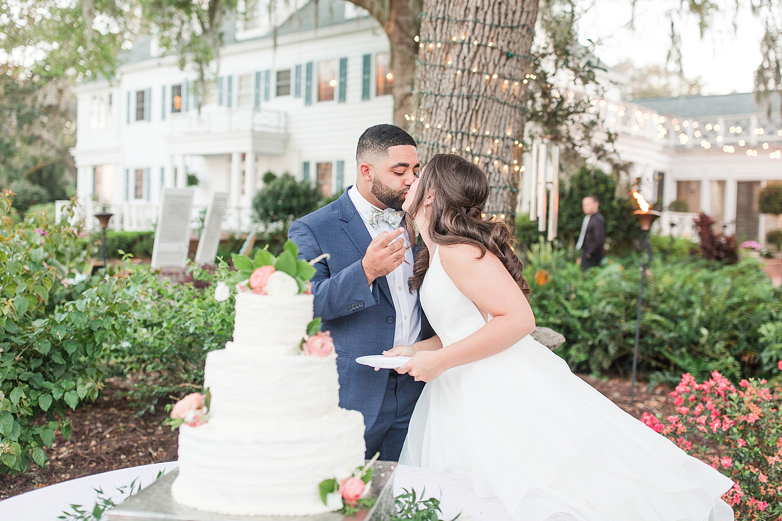 Enchanted Oaks Jacksonville Wedding Bride and Groom Kissing after Cutting Cake Photo