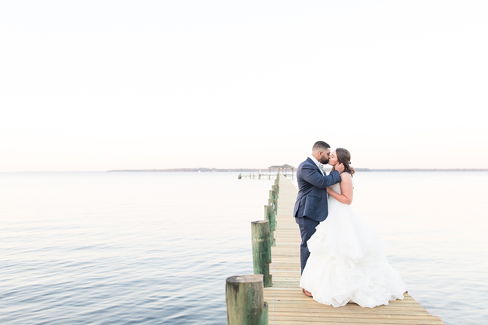 Enchanted Oaks Jacksonville Wedding Bride and Groom Kissing on Dock of the St Johns River Photo