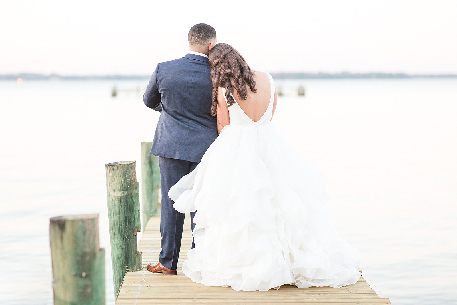 Enchanted Oaks Jacksonville Wedding Bride and Groom Snuggling on Dock Looking at St Johns River Photo