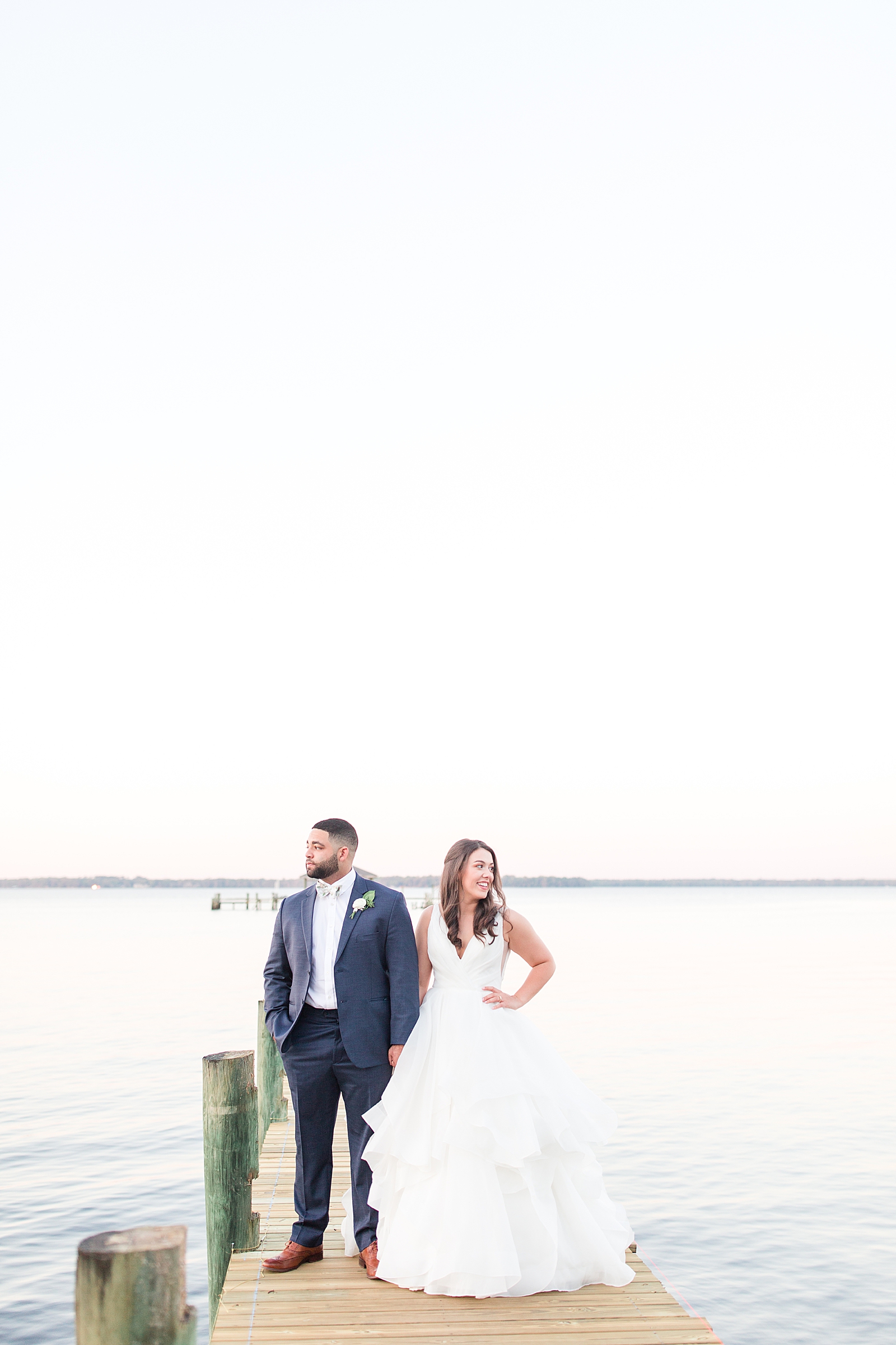 Enchanted Oaks Jacksonville Wedding Bride and Groom on Dock of St Johns River Looking opposite ways Photo