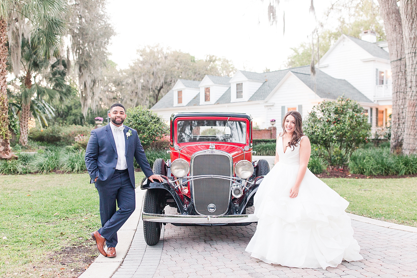 Enchanted Oaks Jacksonville Wedding Bride and Groom in Front of Red Vintage Chevrolet Photo