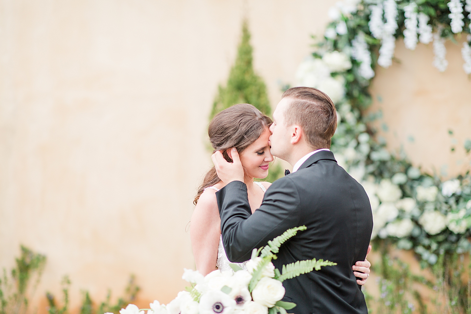 Montaluce Winery Wedding Ceremony Groom Kissing Bride on Forehead Photo