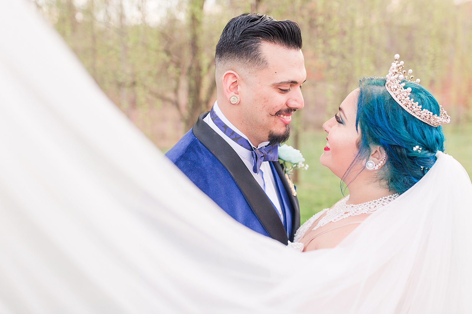 Mooresville Wedding Bride and Groom Smiling at each other with veil sweeping in front Photo