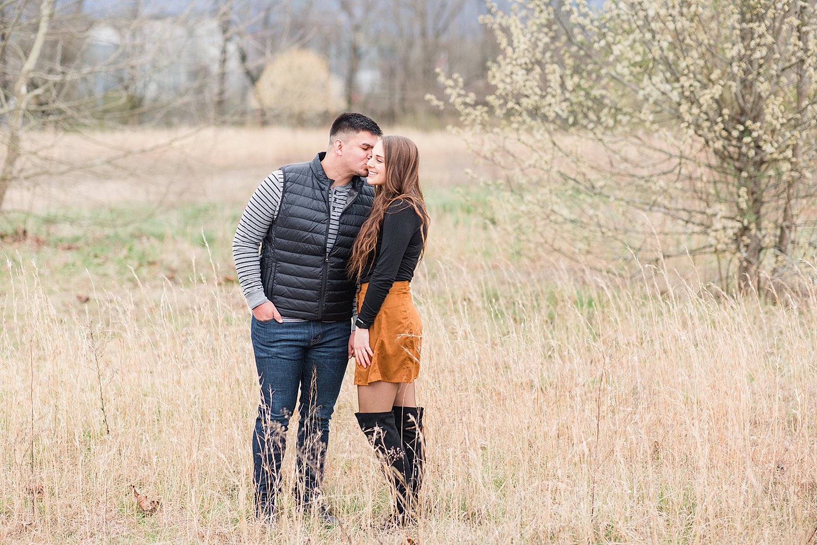 Andrews NC Spring Session Spencer kissing Erin on the cheek in field Photo