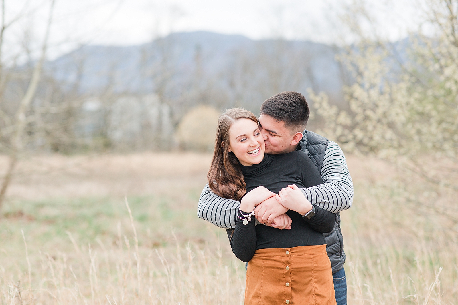 Andrews NC Spring Session Spencer Kissing Erin on cheek in field Photo