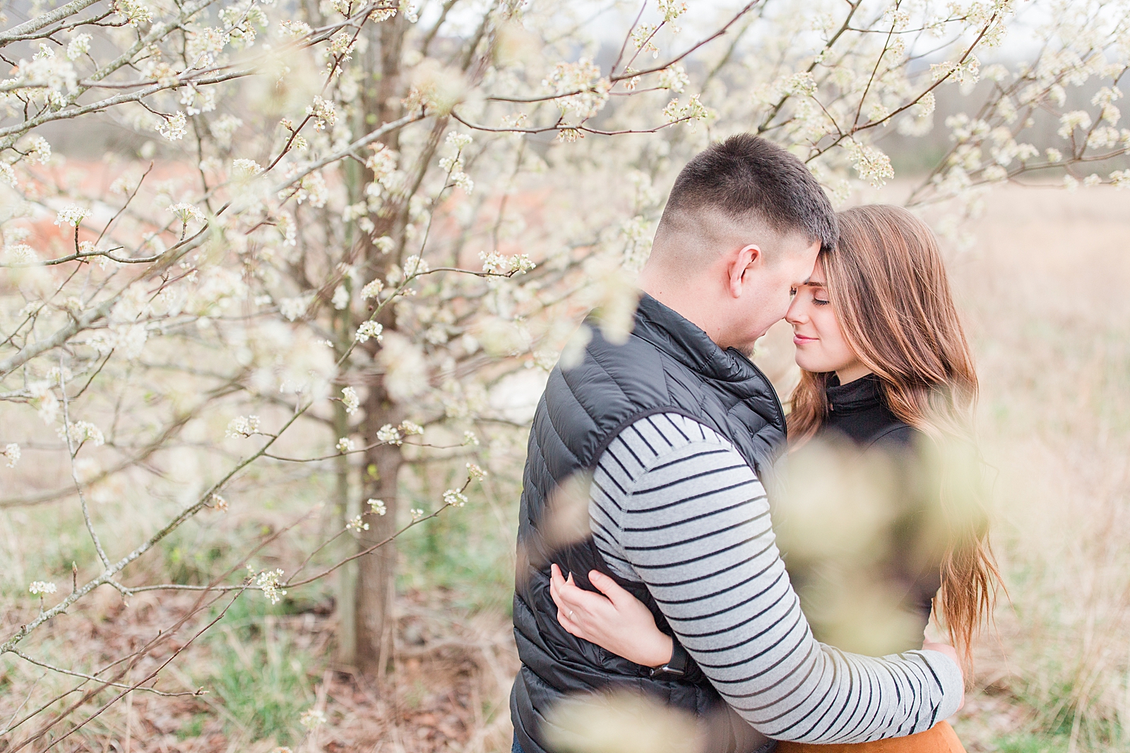 Andrews NC Spring Session Couple hugging nose to nose in blooming trees Photo