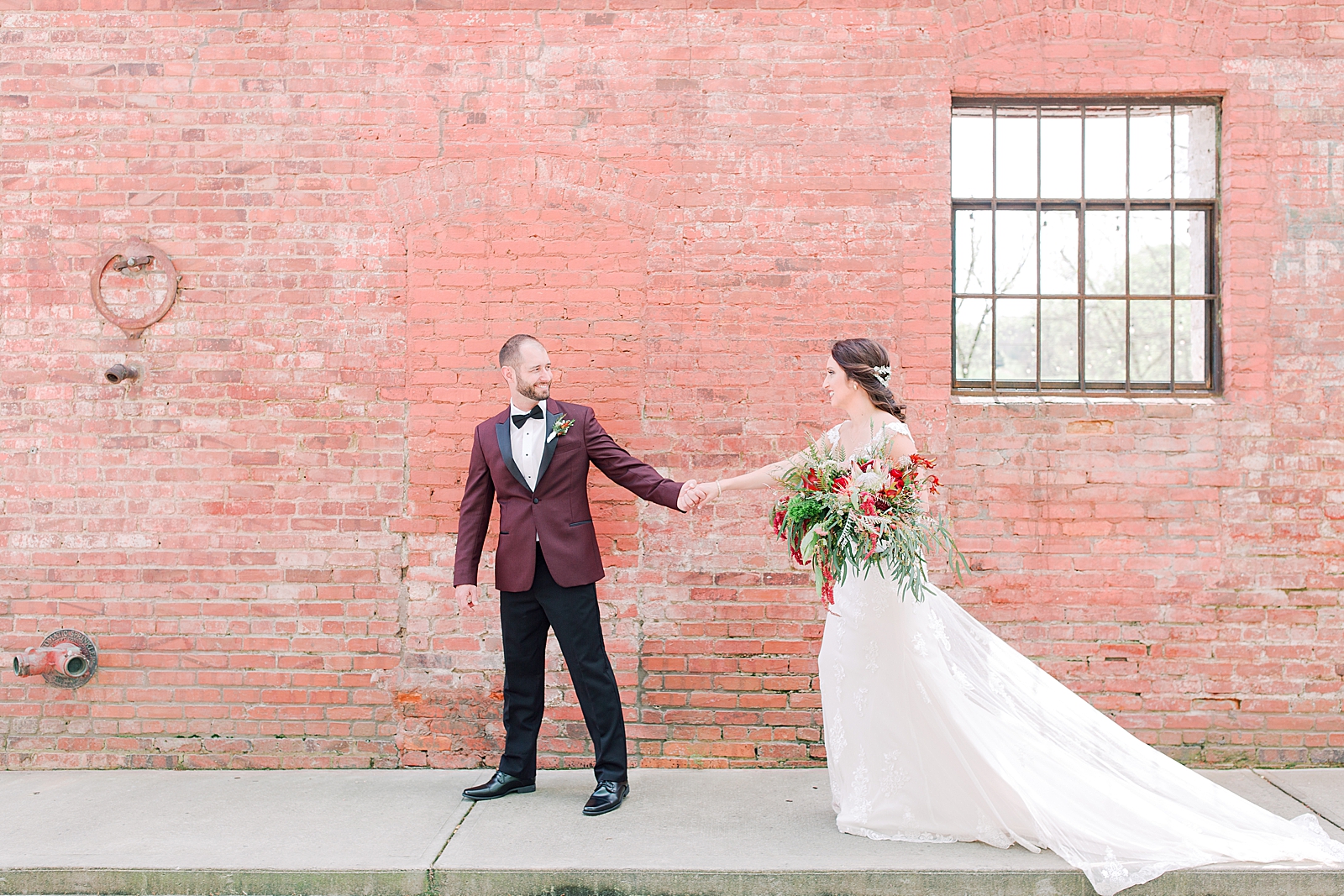 Hackney Warehouse Wedding Bride and Groom holding hands walking on sidewalk Photo