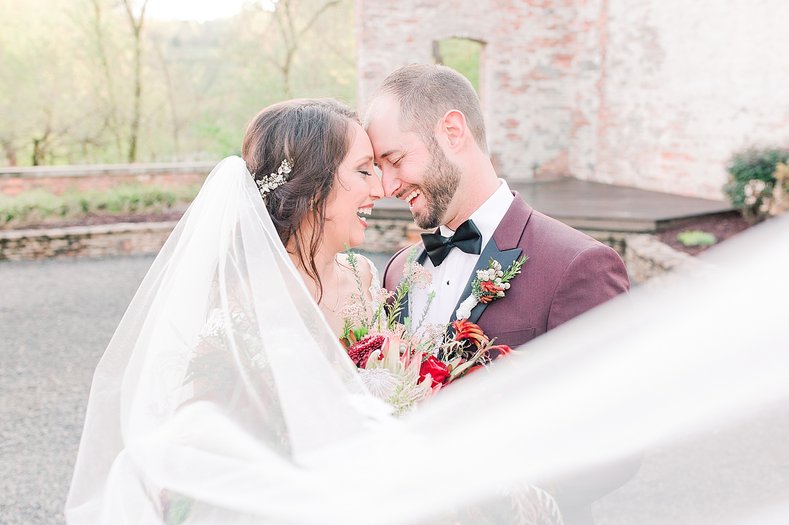 Hackney Warehouse Wedding Bride and Groom Laughing Nose to Nose with veil sweeping in front Photo