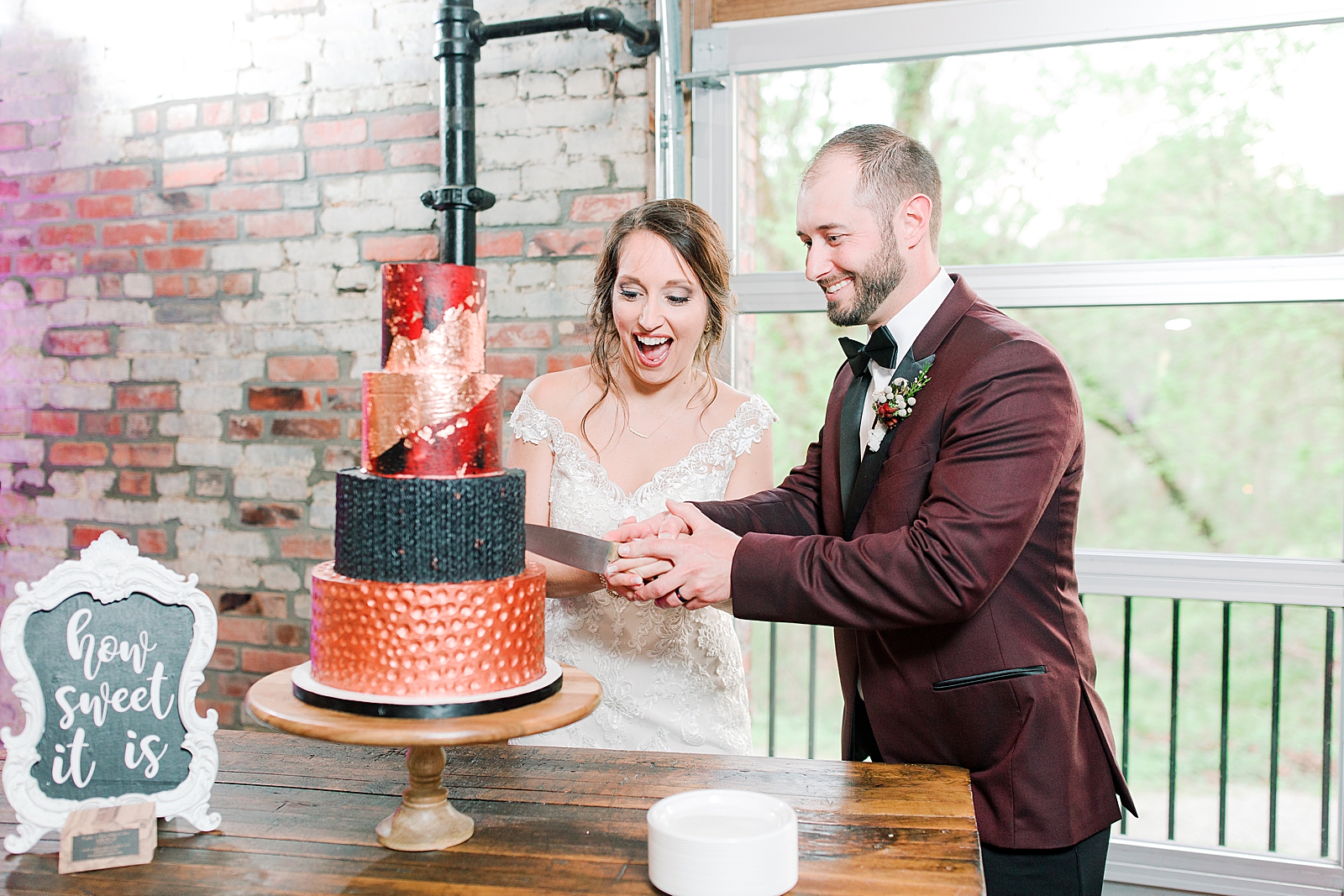 Hackney Warehouse Wedding Reception Bride and Groom Cutting Cake Photo