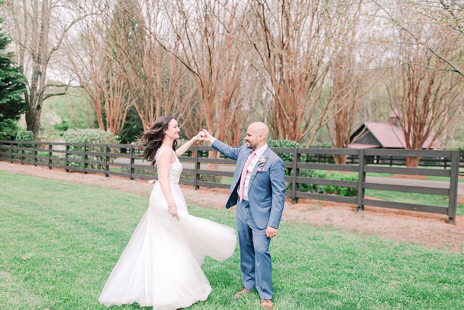 Spring Hawkesdene Wedding Groom twirling bride in field Photo