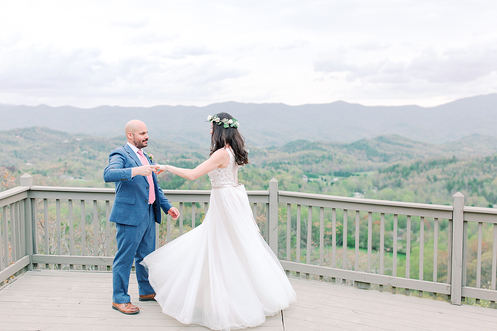 Spring Hawkesdene Wedding Groom twirling bride with mountains in background Photo