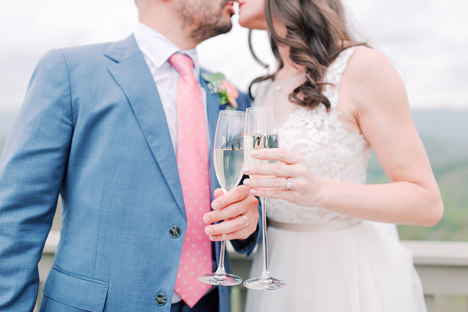 Spring Hawkesdene Wedding Bride and Groom kissing with mr and mrs glasses in front Photo