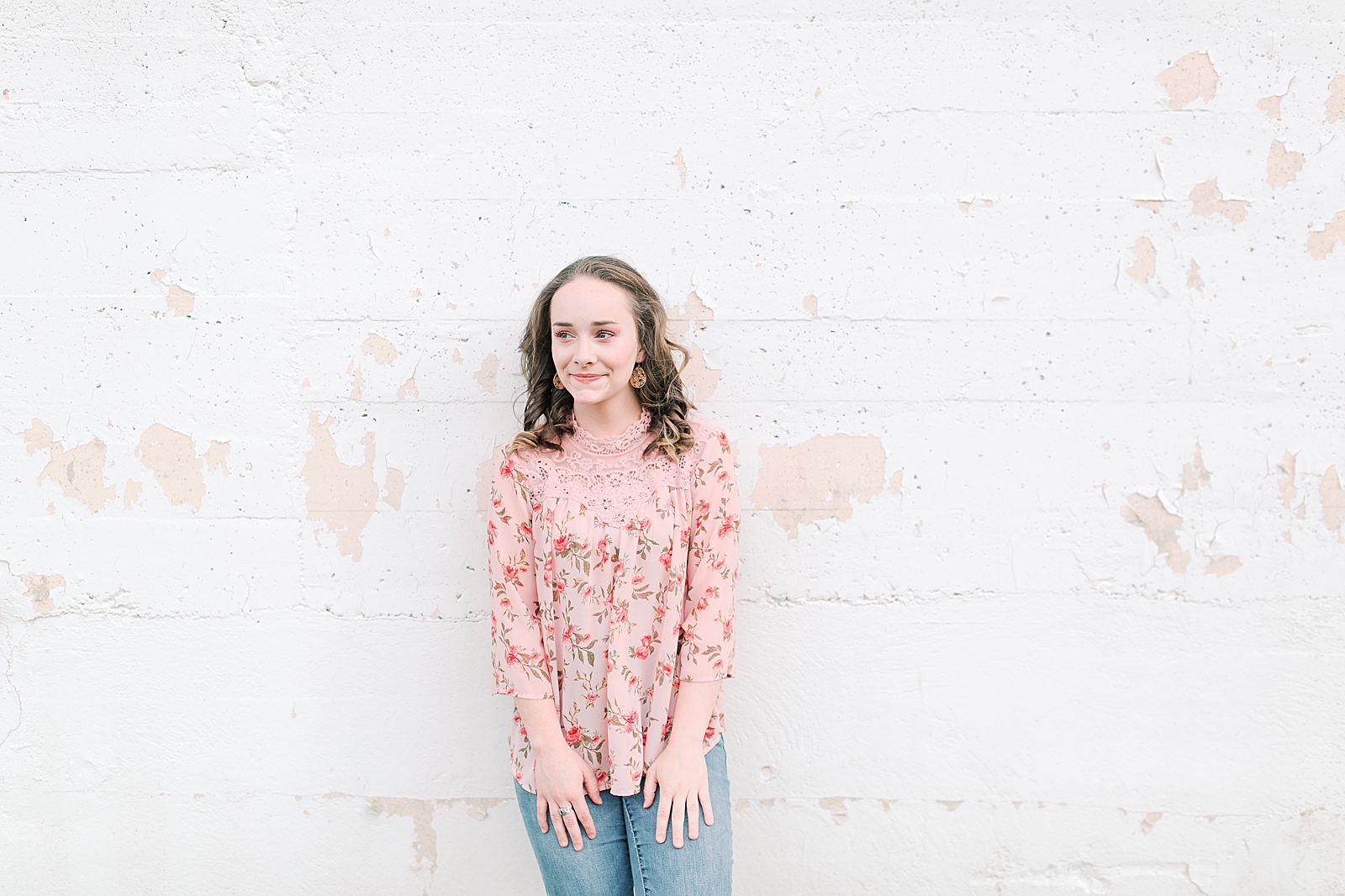 High School Senior Session Zoe leaning against white wall Photo