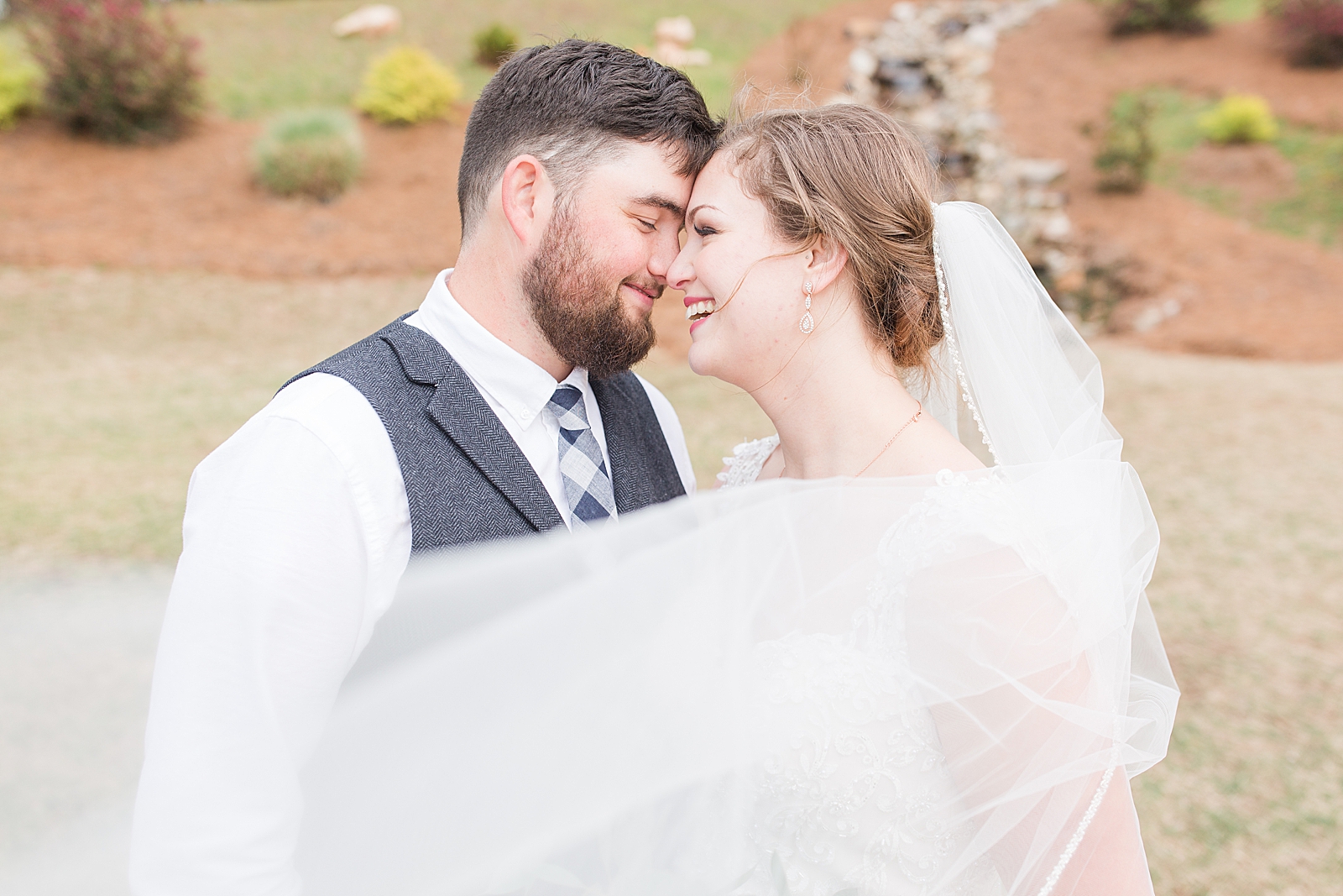 Macedonia Hills Wedding bride and groom smiling with veil sweeping in front photo