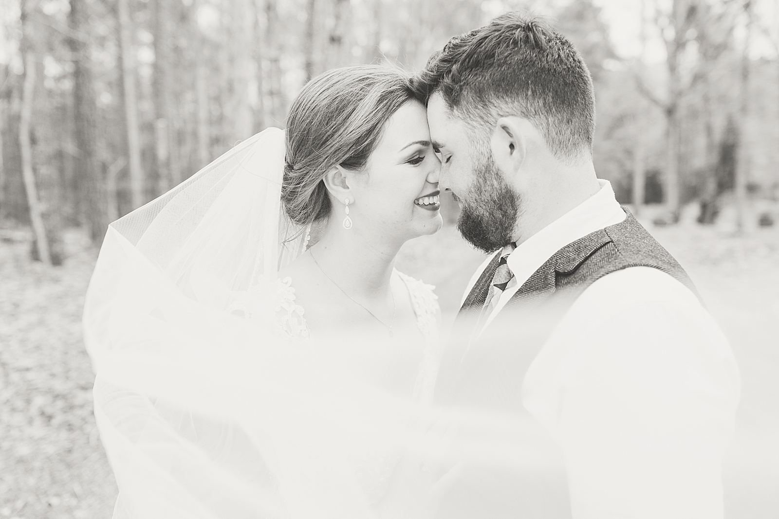Macedonia Hills Wedding black and white of bride and groom nose to nose with veil sweeping in front photo