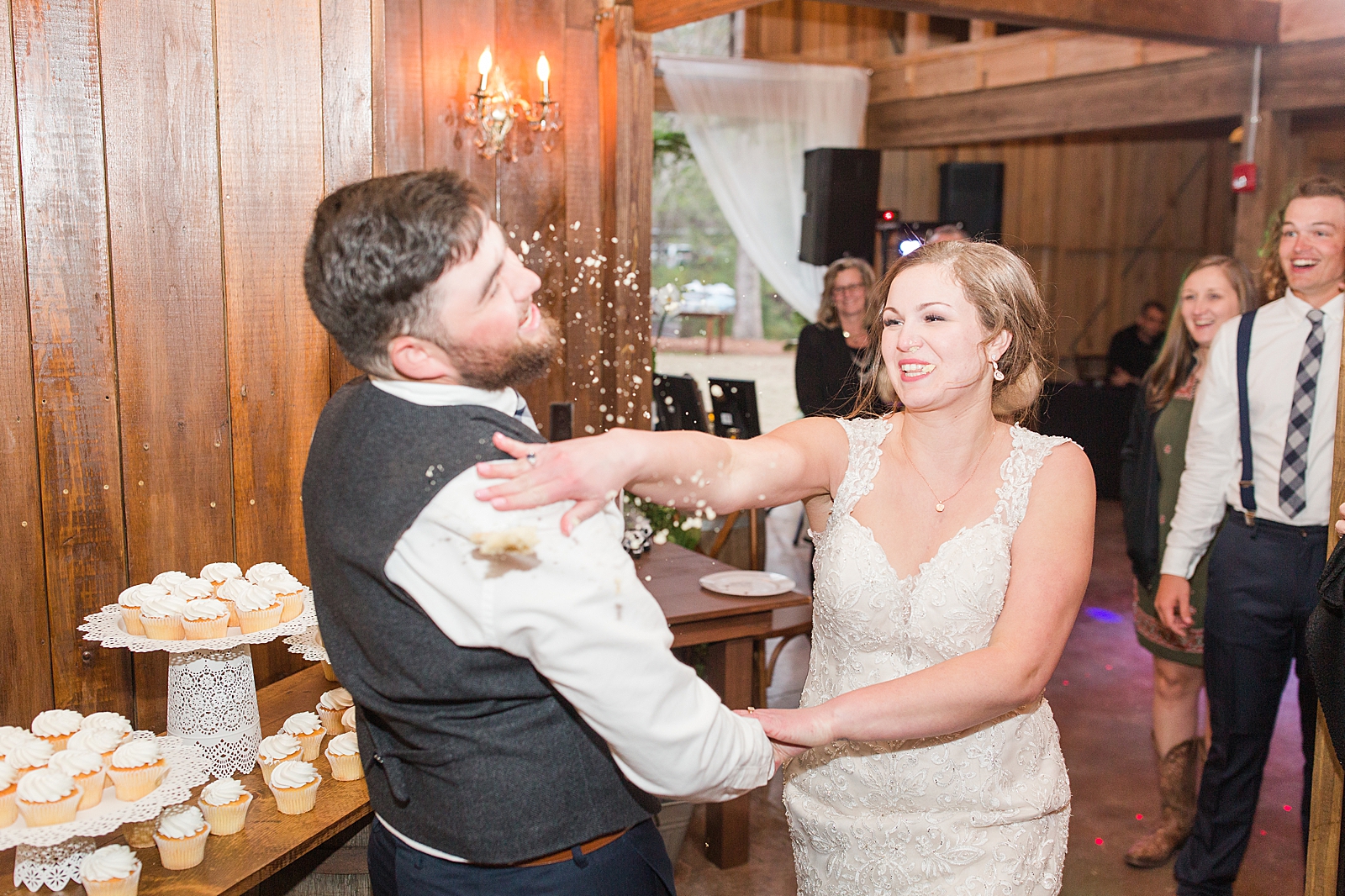 Macedonia Hills Wedding Reception Bride smashing cake in grooms face Photo