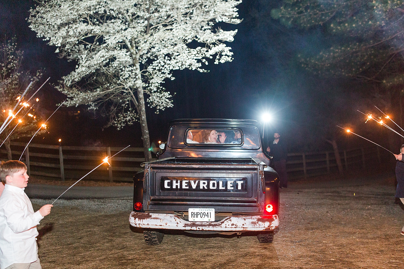 Macedonia Hills Wedding Reception Bride Waving in back of Chevy truck Photo