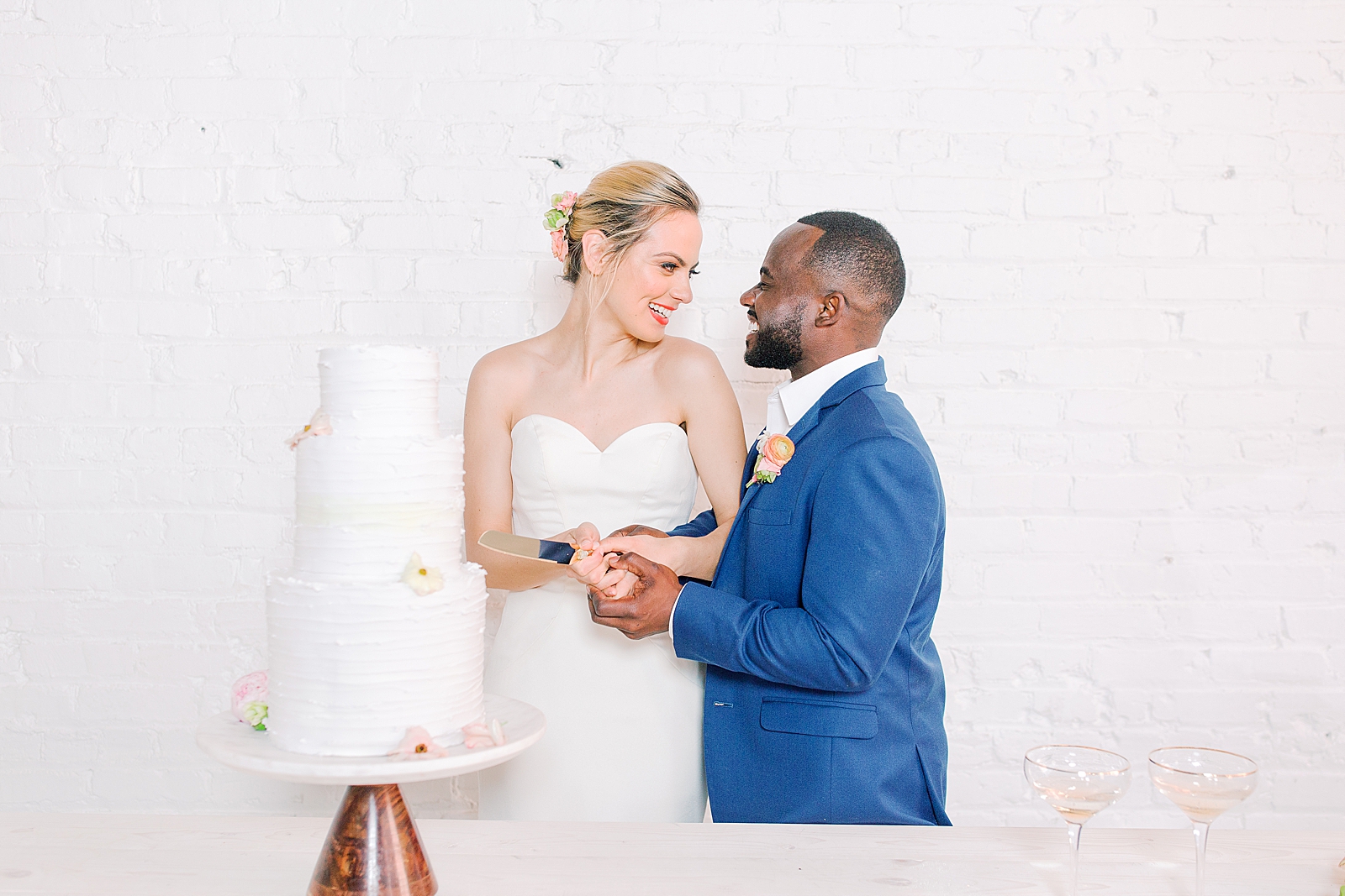 Spring Brickyard Wedding Reception Bride and Groom Cutting Cake Photo