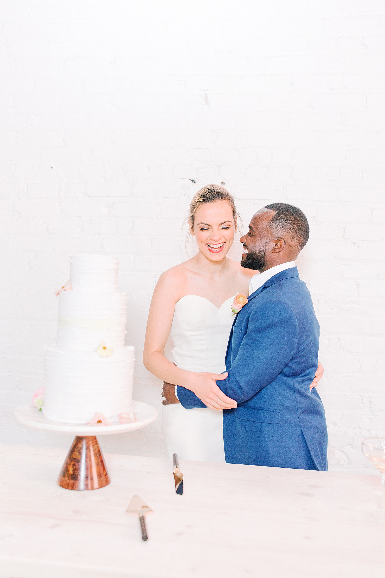 Spring Brickyard Wedding Reception Bride and Groom Cutting Cake Laughing Photo