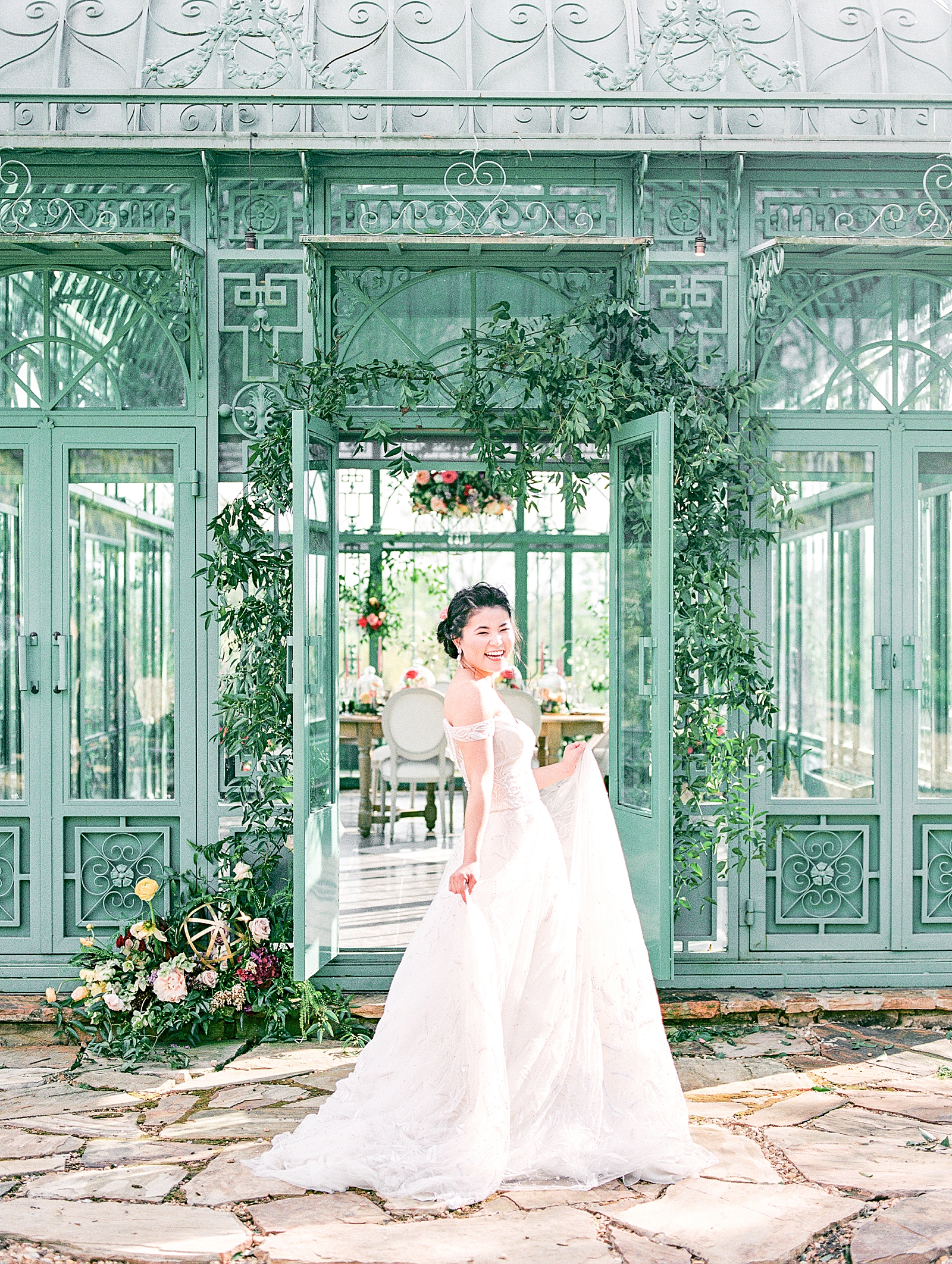 2400 On The River Bridal Session Lily twirling in front of Greenhouse Photo