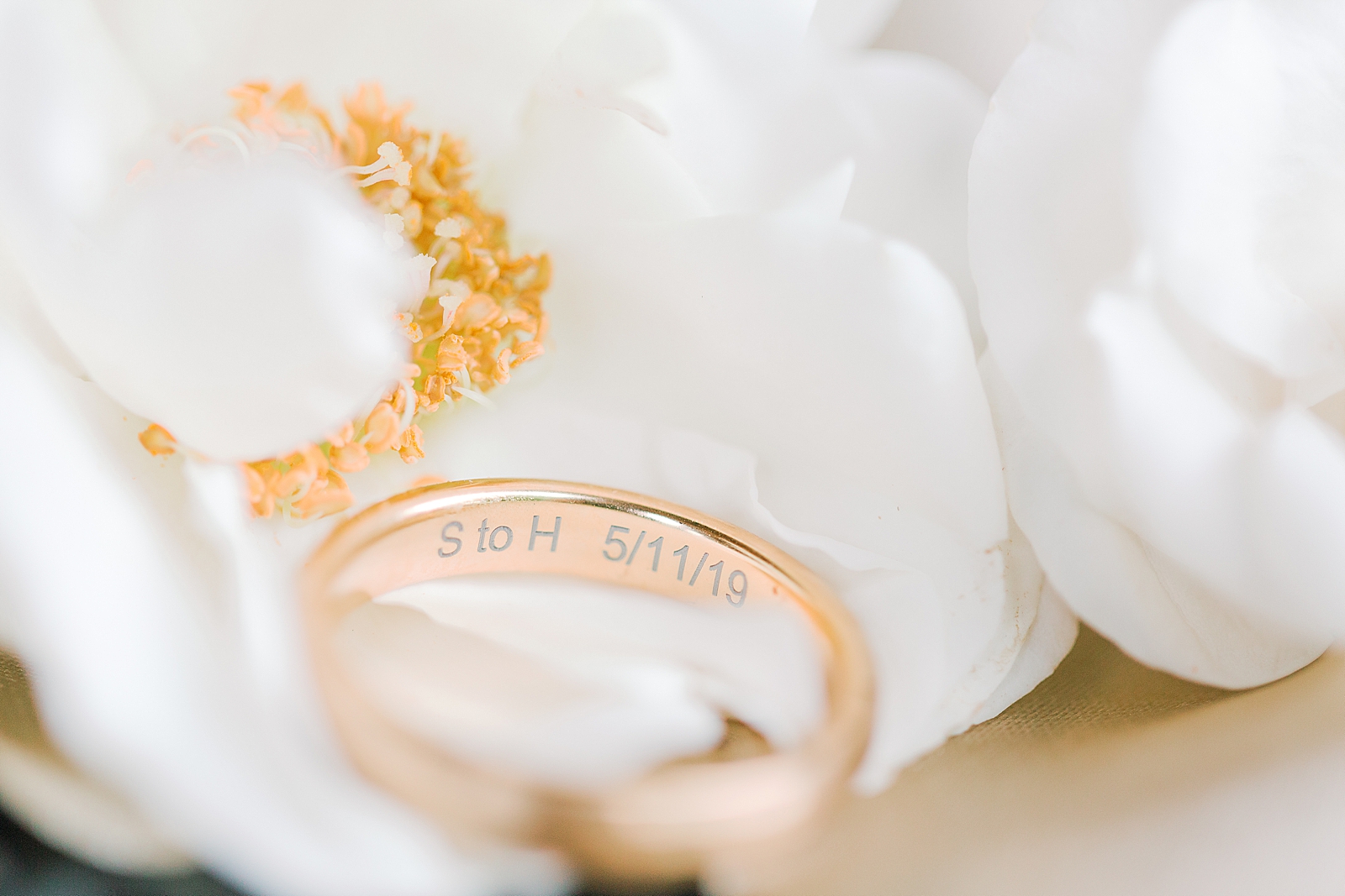 Asheville Wedding Detail of Ring in white flower with inscription on the inside Photo