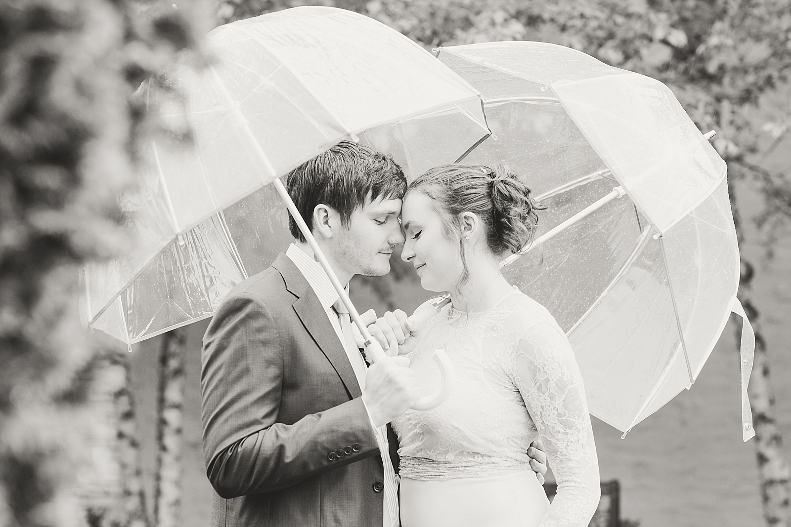 Asheville Wedding Black and White of Bride and Groom nose to nose under umbrellas Photo