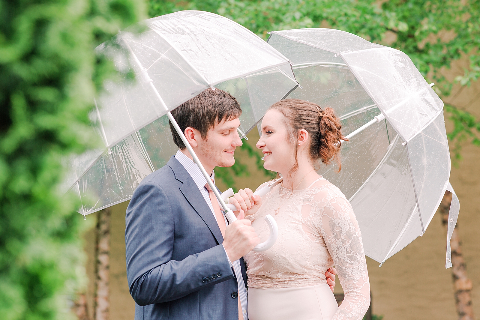 Asheville Wedding Bride and Groom Smiling at each other under umbrellas Photo