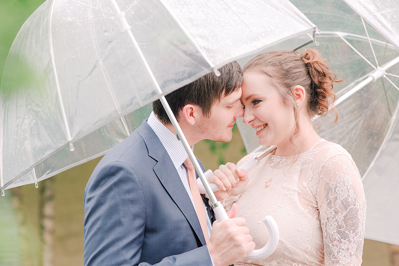 Asheville Wedding couple snuggling under umbrellas Photo