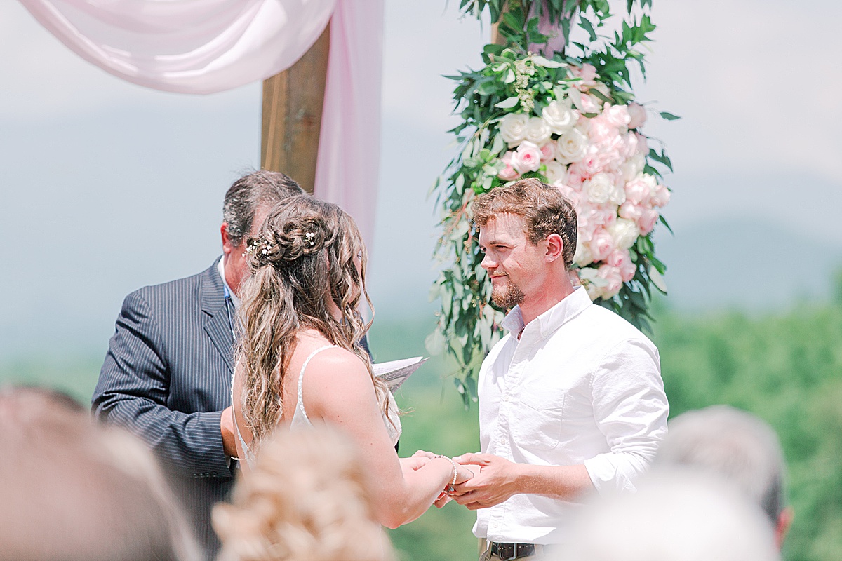 Rustic Spring Mountain Wedding Ceremony Bride and Groom Holding Hands at Alter Photo