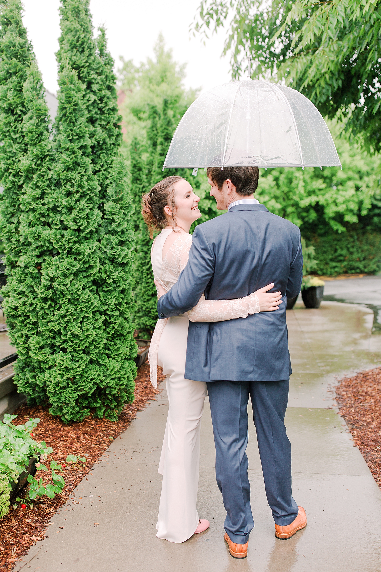 Asheville Wedding Bride and Groom Smiling at each other under umbrella Photo