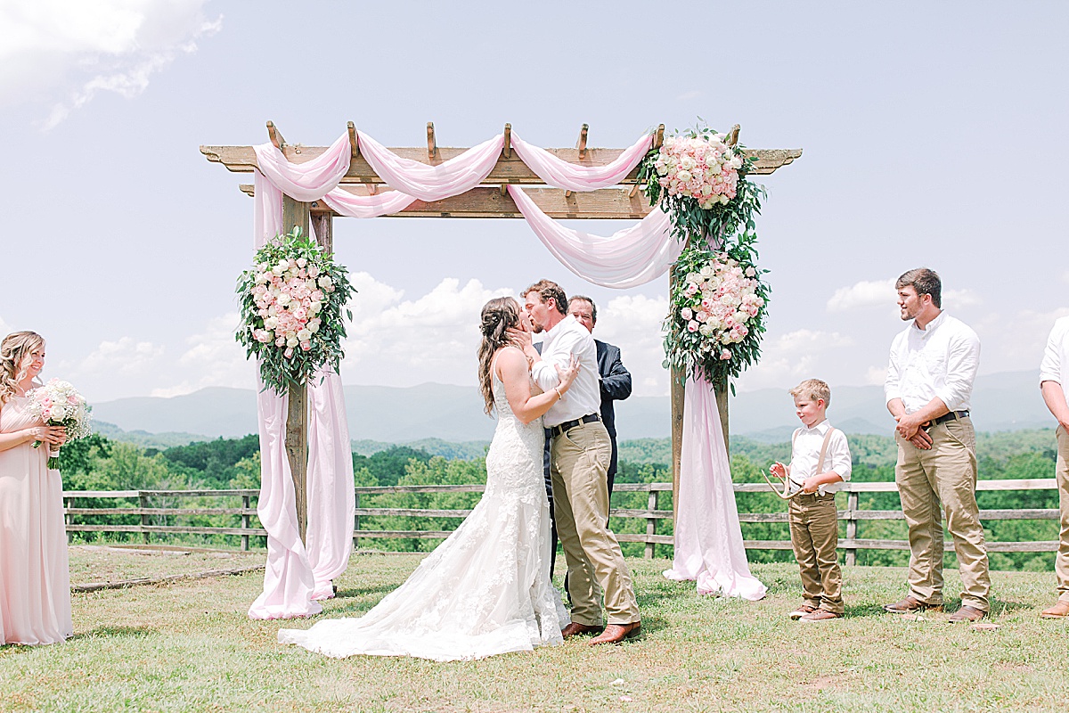 Rustic Spring Mountain Wedding Ceremony Bride and Groom's First Kiss Photo