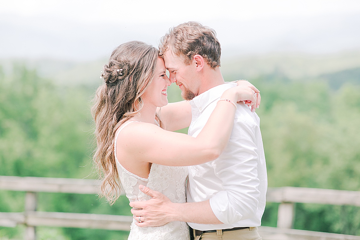 Rustic Spring Mountain Wedding Husband and Wife Hugging Nose to Nose Photo