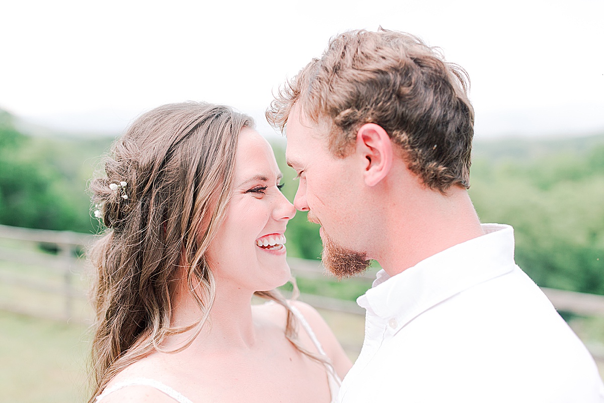 Rustic Spring Mountain Wedding Bride and Groom Smiling at Each other Nose to Nose Photo