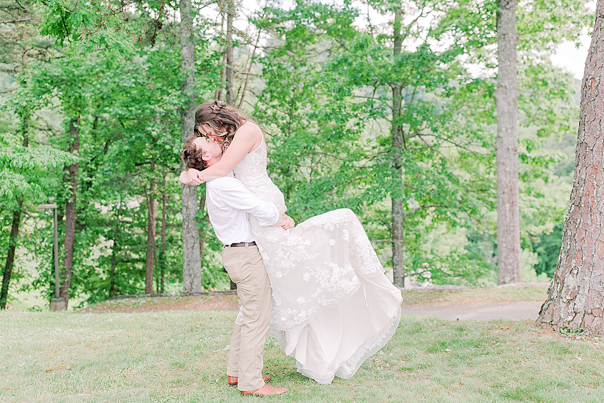 Rustic Spring Mountain Wedding Groom Picking Bride up and Kissing Photo