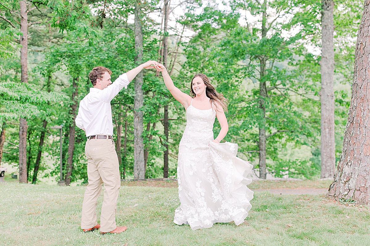 Rustic Spring Mountain Wedding Groom Twirling Bride in the Trees Photo