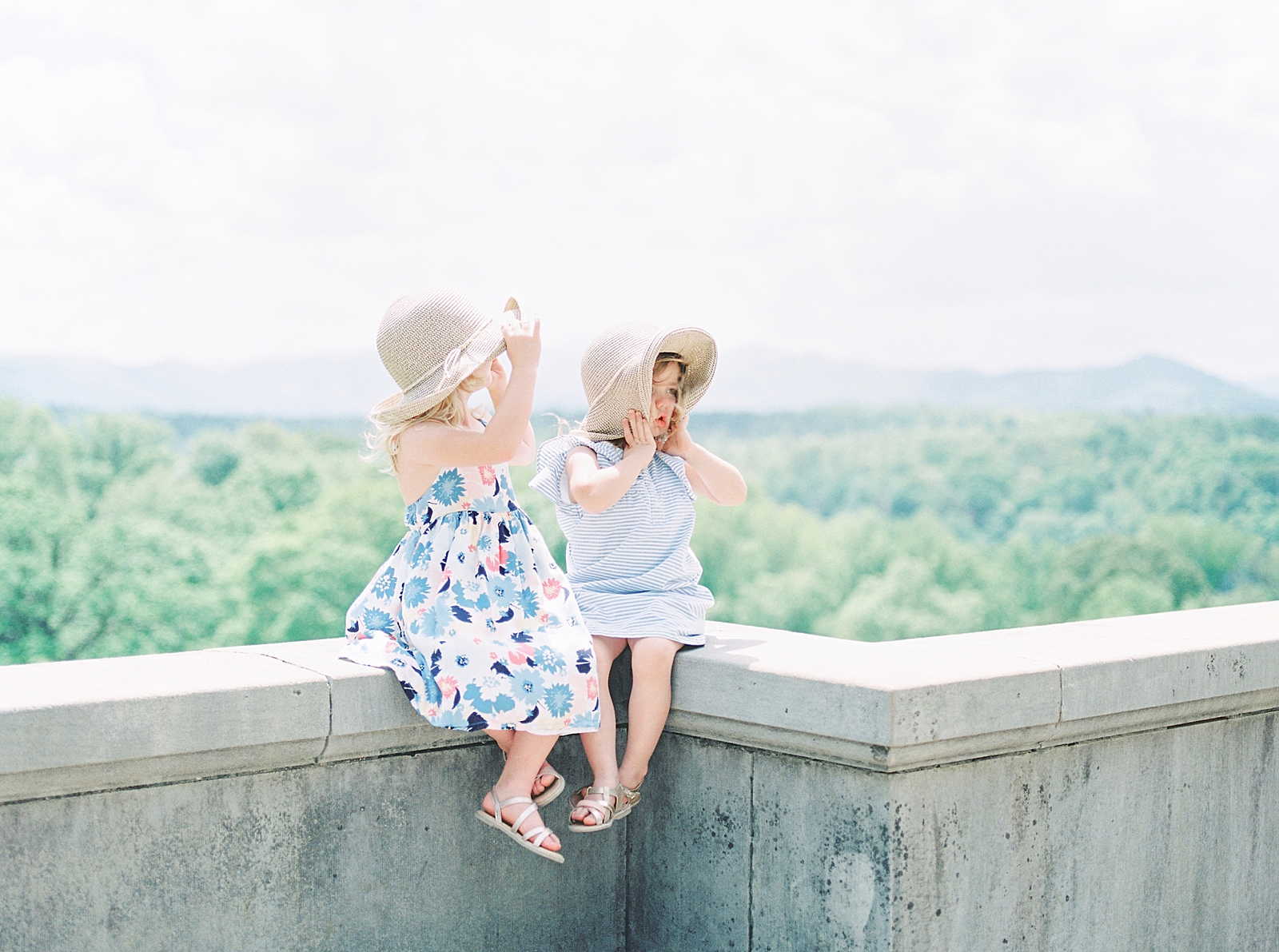 Biltmore House and Gardens little girls sitting on wall overlooking mountains Photo