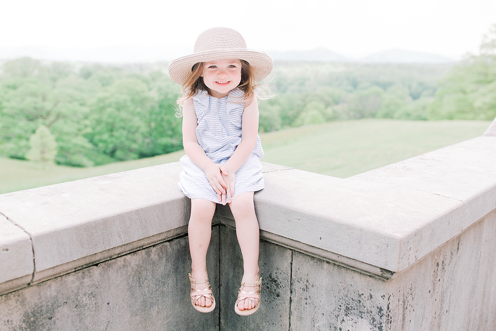 Biltmore House and Gardens Little girl smiling sitting on wall Photo