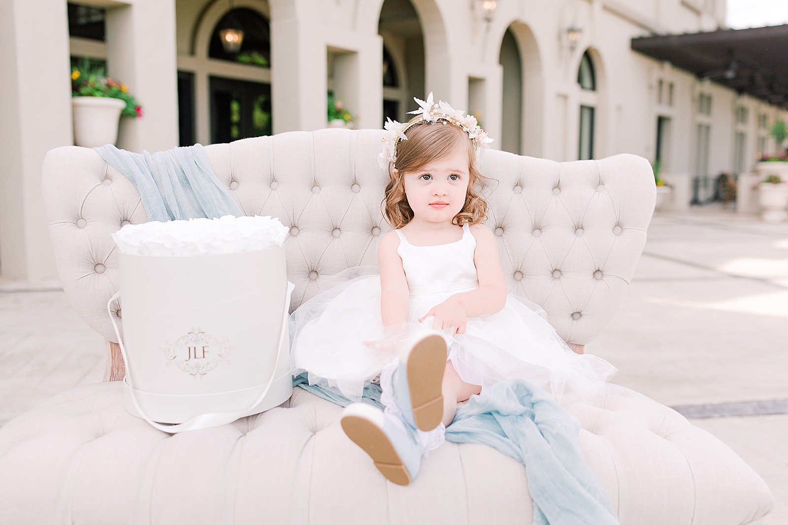 Chateau Elan Little girl on Settee with bucket of white roses Photo