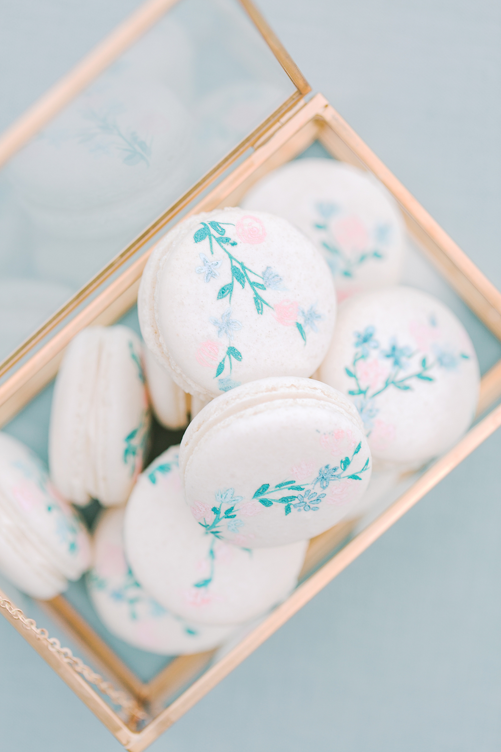 Chateau Elan floral macaroons in gold and glass box Photo