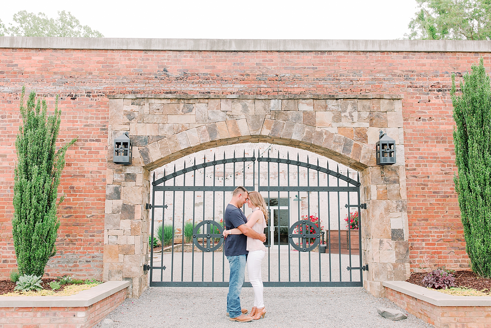 Hackney Warehouse Engagement Session Couple nose to nose in front of iron gate Photo
