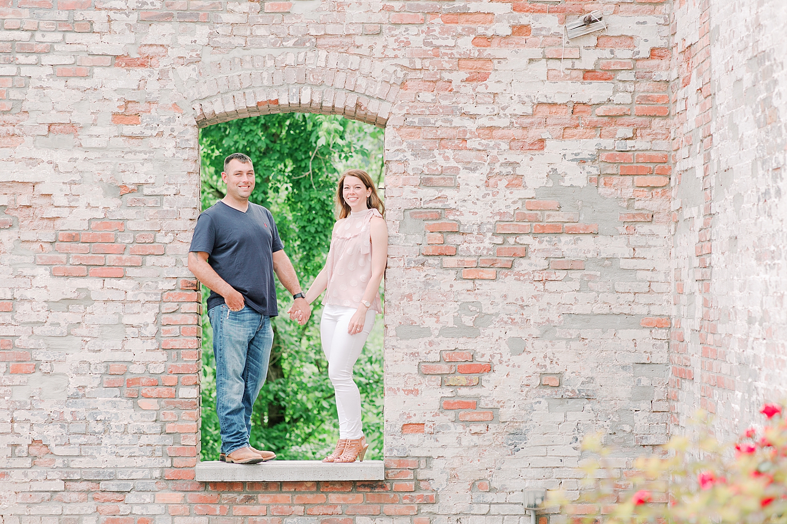Hackney Warehouse Engagement Session Couple standing in brick archway Photo