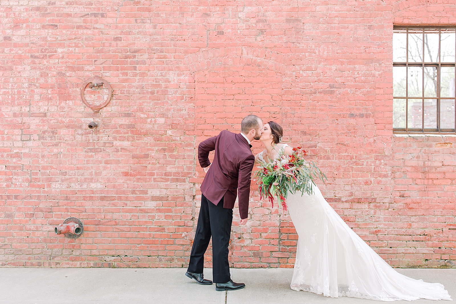 Hackney Warehouse Wedding Bride and Groom Kissing on Sidewalk Photo