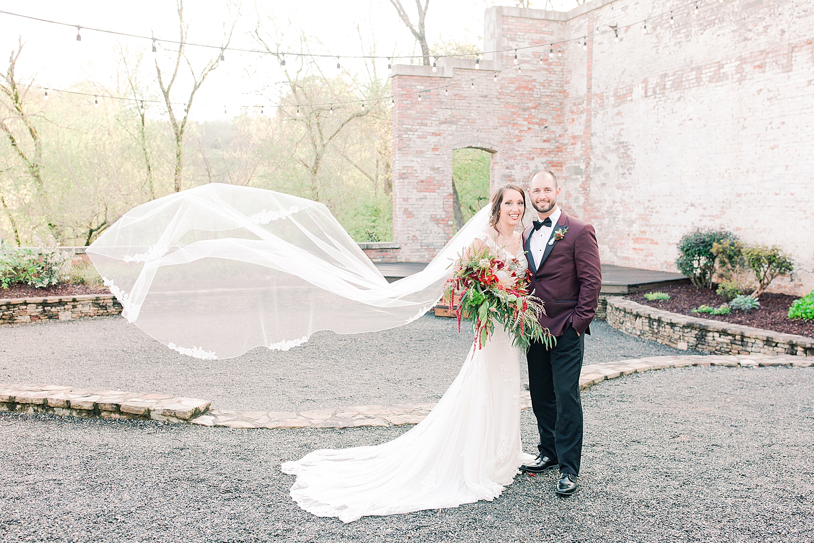 Hackney Warehouse Wedding Bride and Groom smiling at camera with veil blowing in the wind Photo