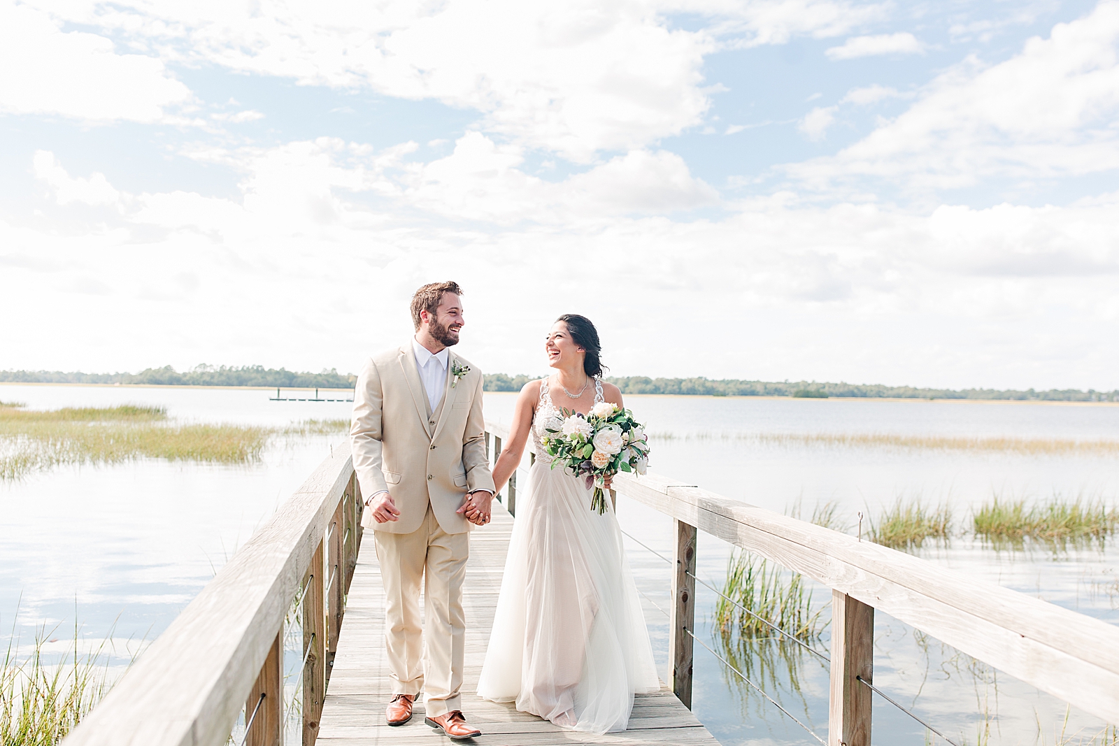 Charleston Wedding at Lowndes Grove Bride and Groom holding hands on the dock Photo